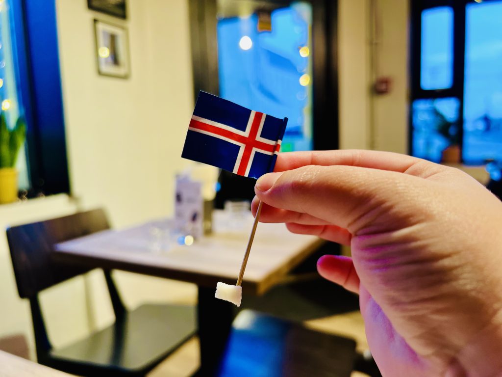 Small piece of hákarl fermented shark with an Icelandic flag at Café Loki in Reykjavík