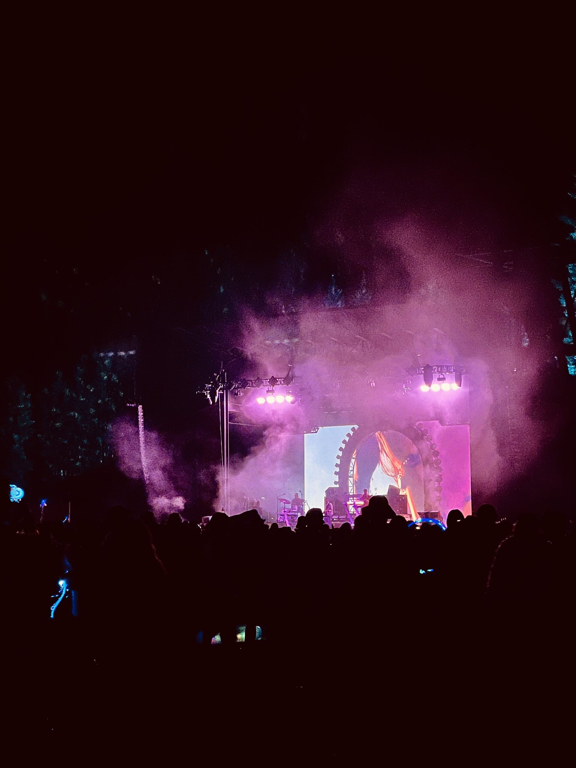 Tycho’s live band performing under pink stage lights at Camp Alderwild in Telluride
