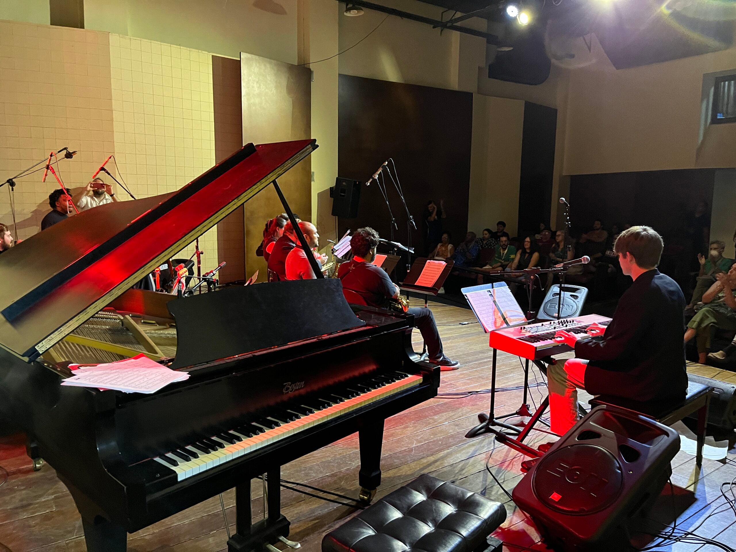 Student ensemble performing with piano and saxophones for a university audience in Rio de Janeiro