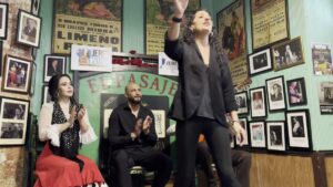 A dancer performs while seated artists clap at Tabanco El Pasaje in Jerez.